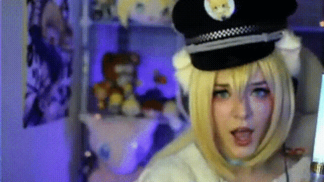 a woman in a police hat is making a funny face