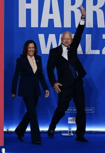 a man and a woman standing in front of a sign that says harr wall