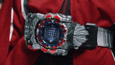 a person is wearing a red jacket and a silver watch
