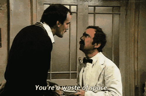 two men are talking to each other and one of them is saying you 're a waste of space