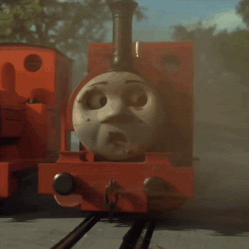 a red train with a muddy face on the front