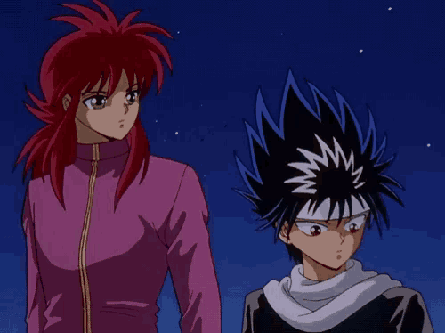 a girl with red hair and a boy with black hair stand next to each other