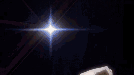 a person 's hands are reaching out towards a bright light in the dark