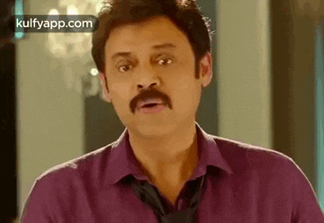 a man with a mustache is wearing a purple shirt and a black tie .