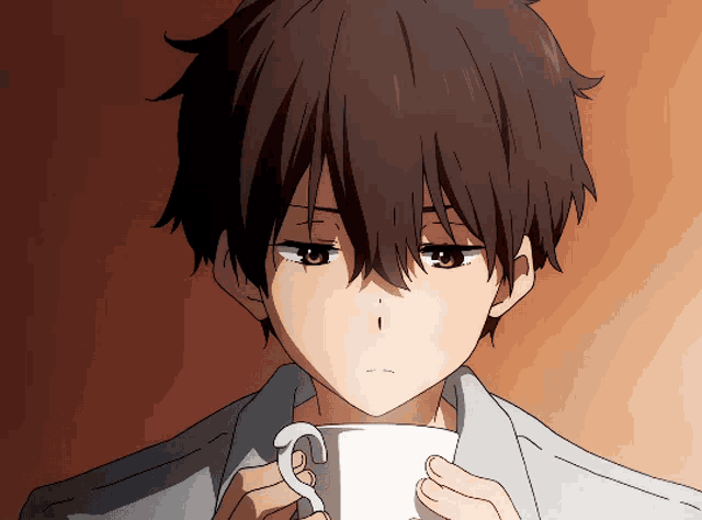 a close up of a boy holding a cup with the letter s on it