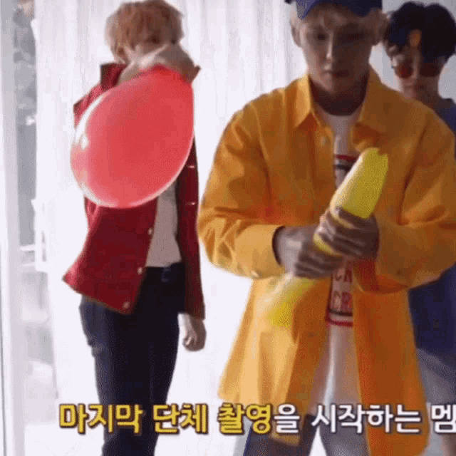 a man in a yellow jacket is holding a water gun