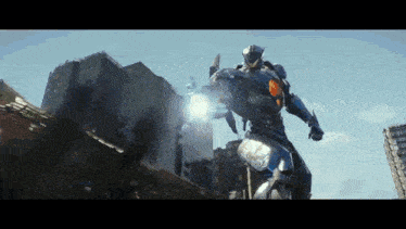 a robot is standing in front of a building in a city and holding a gun .