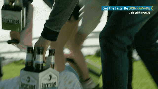 a box of rockshore beer is being opened