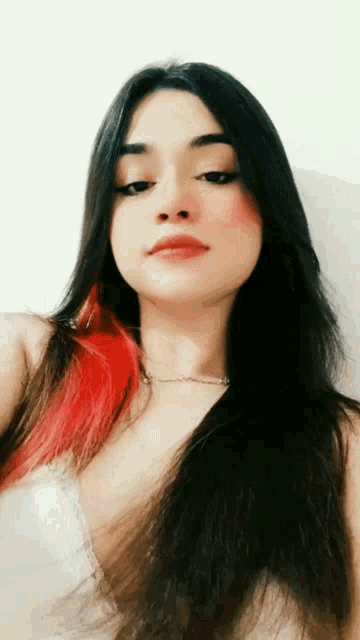 a woman with long black hair and red highlights