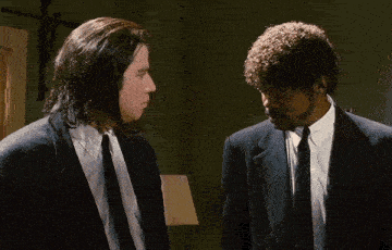 two men in suits are standing next to each other
