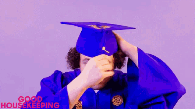 a man in a purple graduation cap and gown with the words good housekeeping in red
