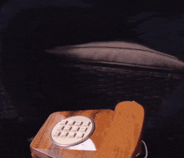 a wooden telephone with the numbers 1 through 12 on the keys