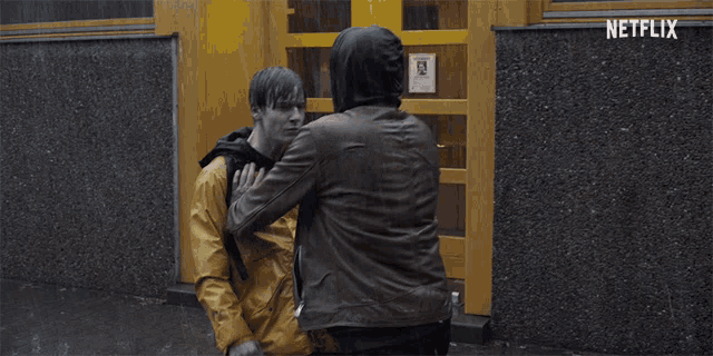 a man in a yellow jacket is laying on the ground with netflix written on the bottom