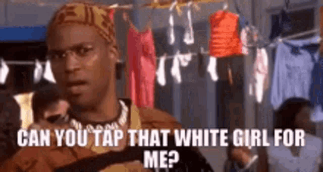a man is standing in a locker room with clothes hanging on a clothes line and asking can you tap that white girl for me