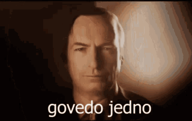 a close up of a man 's face with the words govedo jedno written on the bottom
