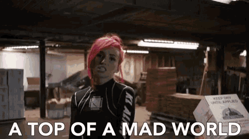 a woman with red hair and the words a top of a mad world below her