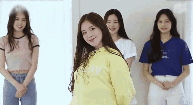 a girl wearing a yellow sweatshirt with the word kitty on it