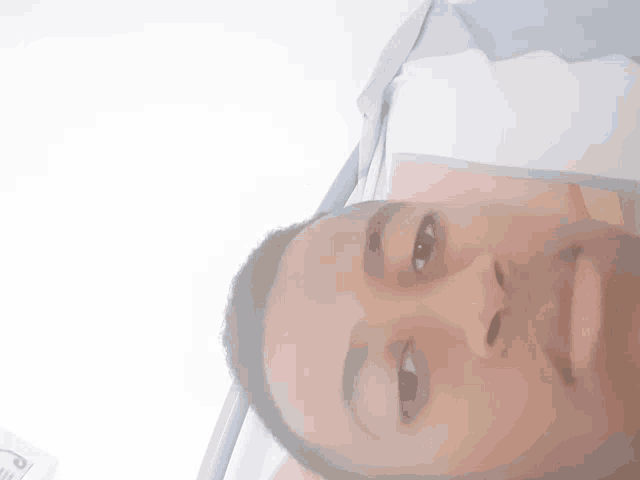 a close up of a person 's face with a nike logo on his shirt