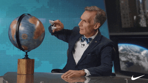 a man sitting at a desk with a globe on it