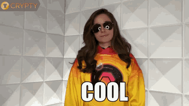 a woman wearing sunglasses and a yellow shirt that says cool on it
