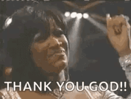 a woman is singing into a microphone with the words `` thank you god '' written below her .