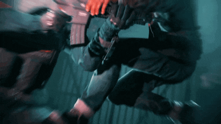 a man is holding a gun while another man is holding a gun