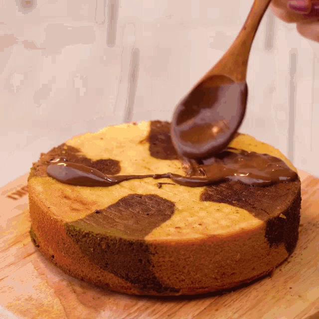 a marble cake is being decorated with chocolate