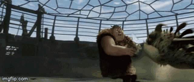 a gif of a man fighting a dragon with the url imgflip.com visible