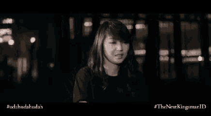a woman is making a funny face in a dark room .
