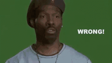 a man wearing a hat and a necklace is standing in front of a green background and says wrong .