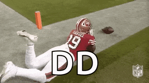 a football player is laying on the ground with the word dd written on the ground .