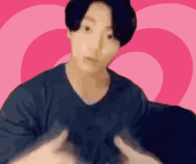a blurry picture of a man 's face with a pink background .