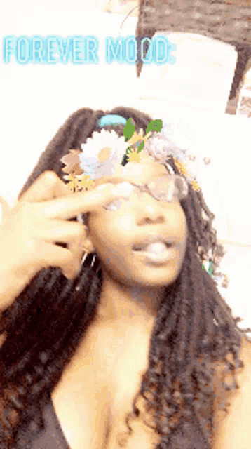 a woman wearing a flower crown on her head with the words forever mood written above her