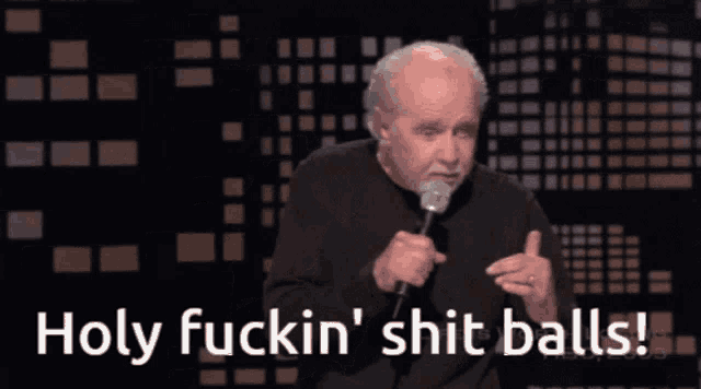 a man with a microphone says holy fuckin shit balls