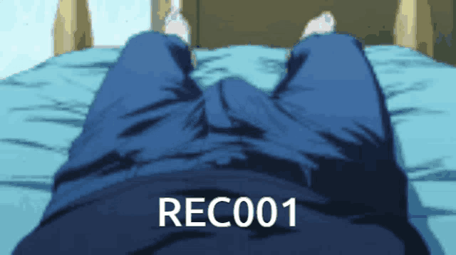 a blurry picture of a person laying on a bed with the words rec001 on the bottom