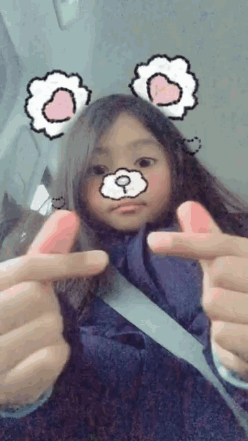 a girl with a teddy bear face and flower ears is making a peace sign