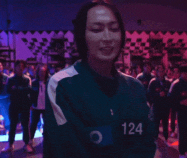 a woman is wearing a jacket with the number 124 on it .
