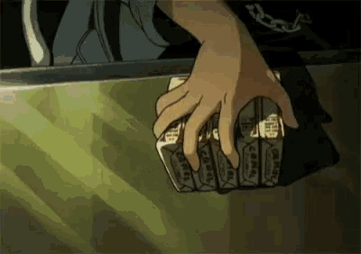 a person is holding a bunch of money in their hands .
