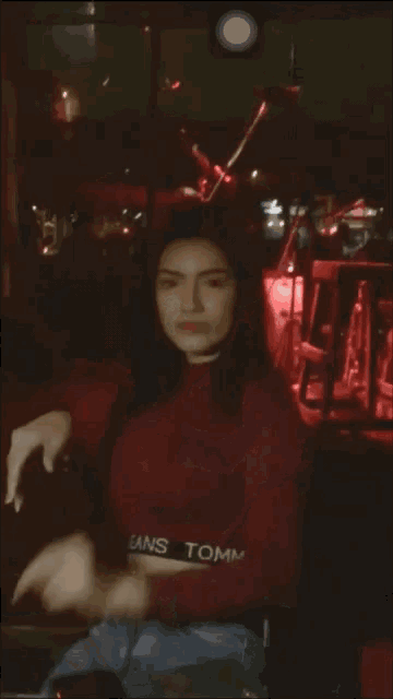 a blurry photo of a woman in a red top