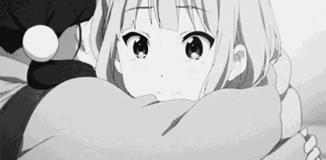 a black and white photo of a girl wrapped in a scarf .