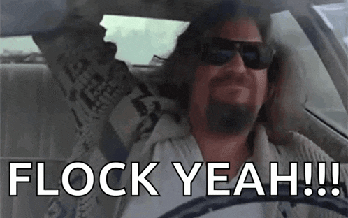 a man wearing sunglasses is driving a car and says flock yeah