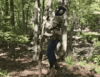 a person is standing in the woods with a backpack on .