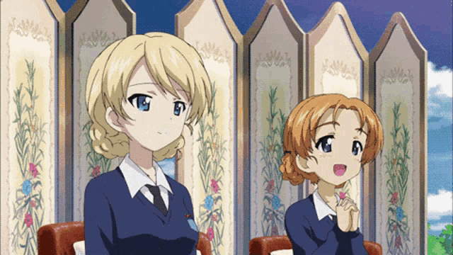 two anime girls are sitting next to each other in front of a screen