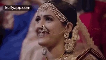 a close up of a bride wearing a nose ring and jewelry .