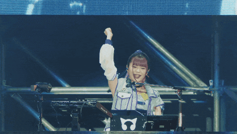 a girl with pink hair is playing a dj set with a pioneer keyboard