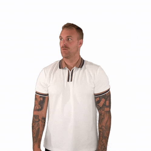 a man with a tattoo on his arm is holding his finger to his mouth