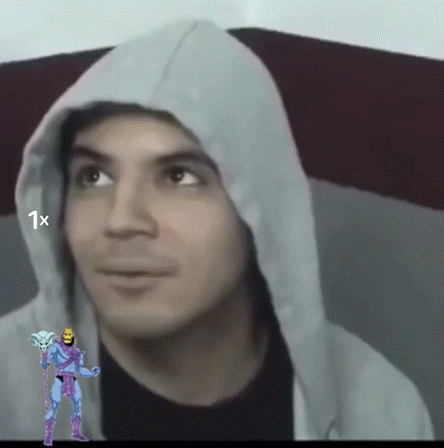 a man wearing a hoodie has a picture of a skeletor behind him