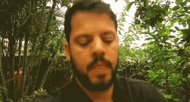 a man with a beard has his eyes closed