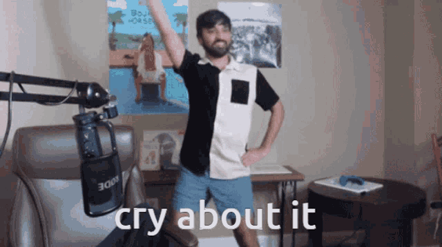 a man standing in front of a microphone with the words cry about it written below him