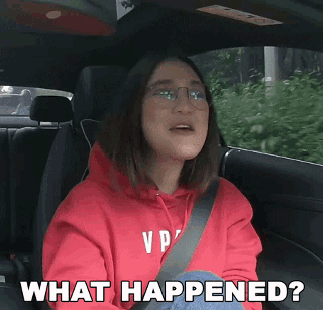 a woman in a red hoodie is sitting in the back seat of a car and says what happened